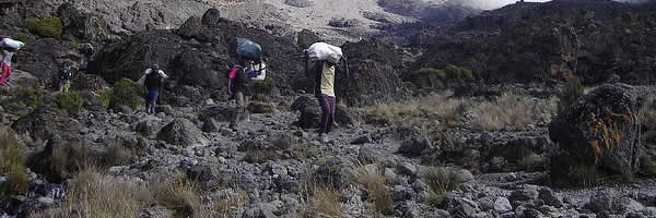 Trekking Mount Kilimajaro Porters Carrying Loads
